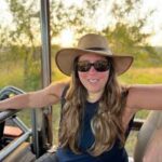 a woman wearing a hat and sunglasses